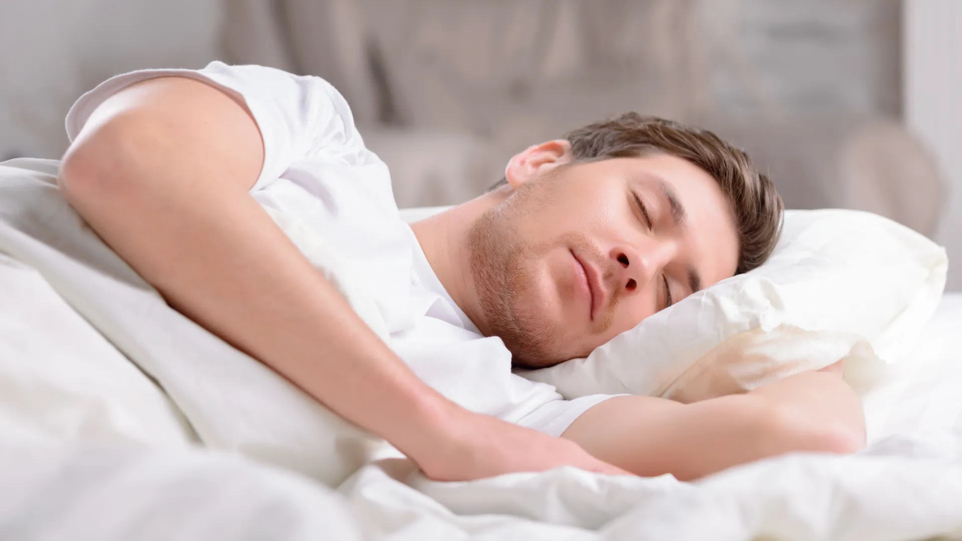 Man taking a nap in a peaceful bedroom